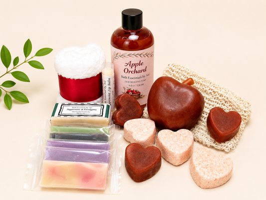 Apple Orchard bath gift set with amber bottle, scented candle tin, heart soaps, and mesh pouch