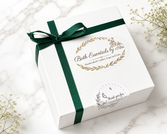 Gift box with green ribbon and Bath Essentials label on a white box lid