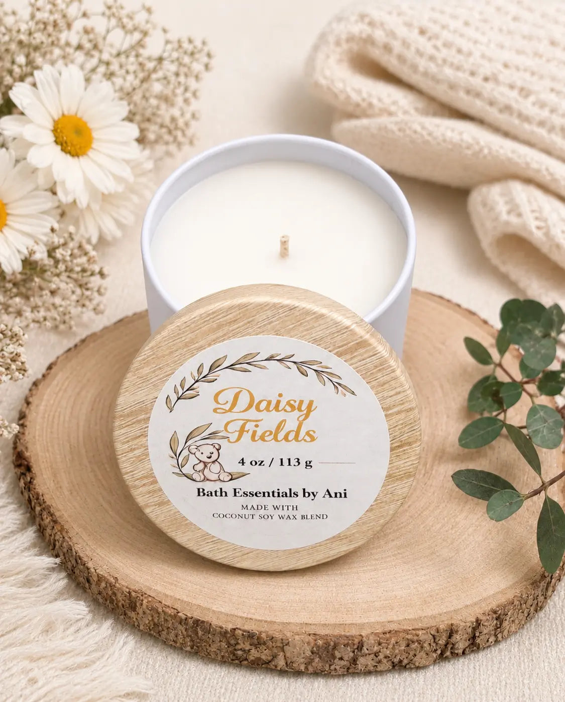 Round wood-slice candle lid with Daisy Fields label and white candle flame