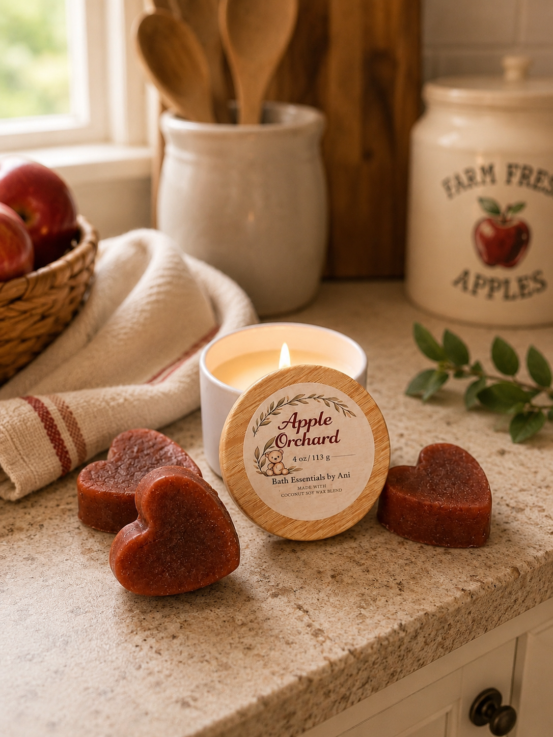 Apple spa gift set with lit candle tin and heart-shaped soaps on countertop