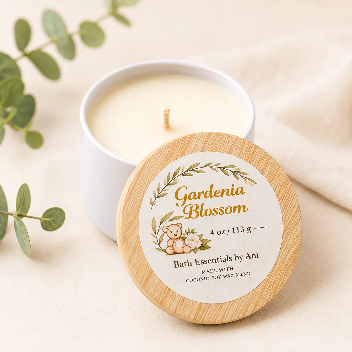 Lit candle with Gardenia Blossom bath soap round and self care gift items