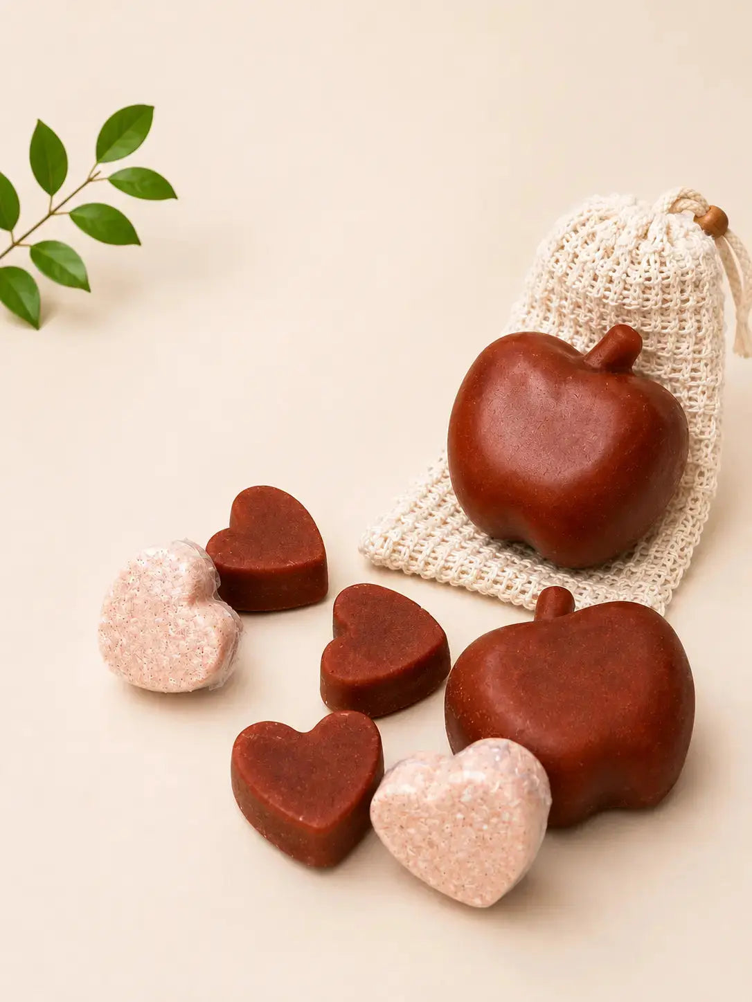 Heart-shaped bath soaps in brown and pink tones with mesh pouch and small soap pieces