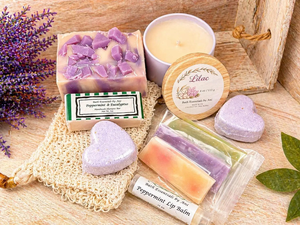 Lilac spa gift set with lavender bars, wax melts, and heart-shaped bath bombs on wood