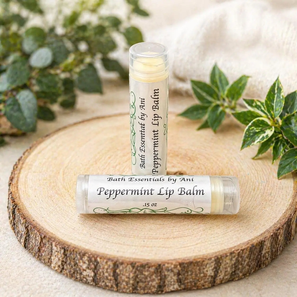 Peppermint lip balm tube on a wooden slice