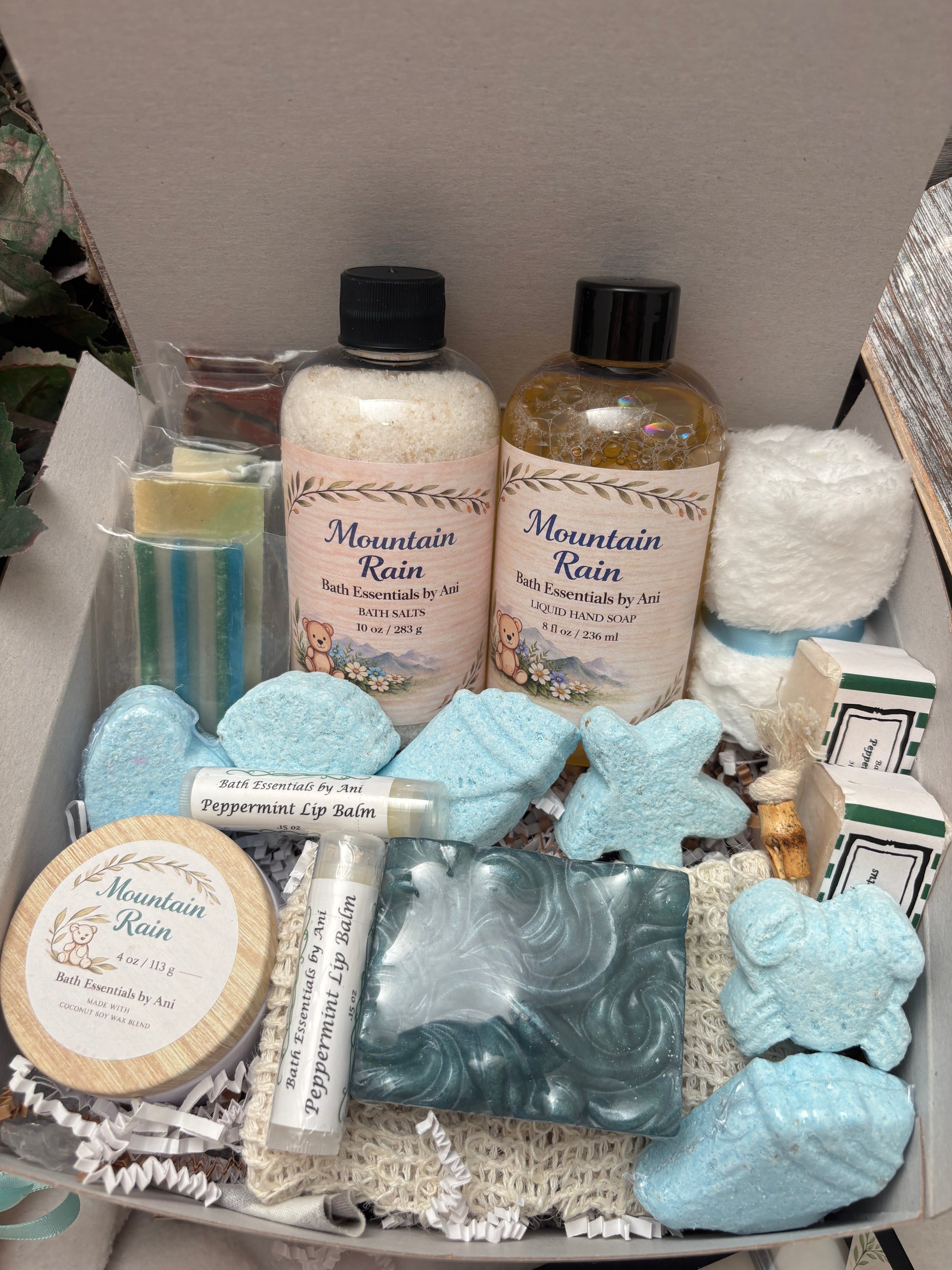 Spa gift box filled with blue bath bombs, soaps, lip balm, bath salts and candle