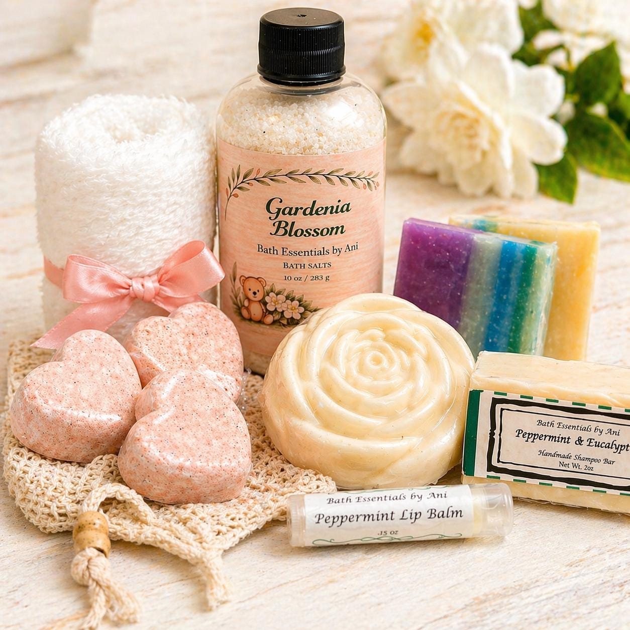 Spa gift set with bath salts bottle, round soap, bath bomb pieces, and lip balm
