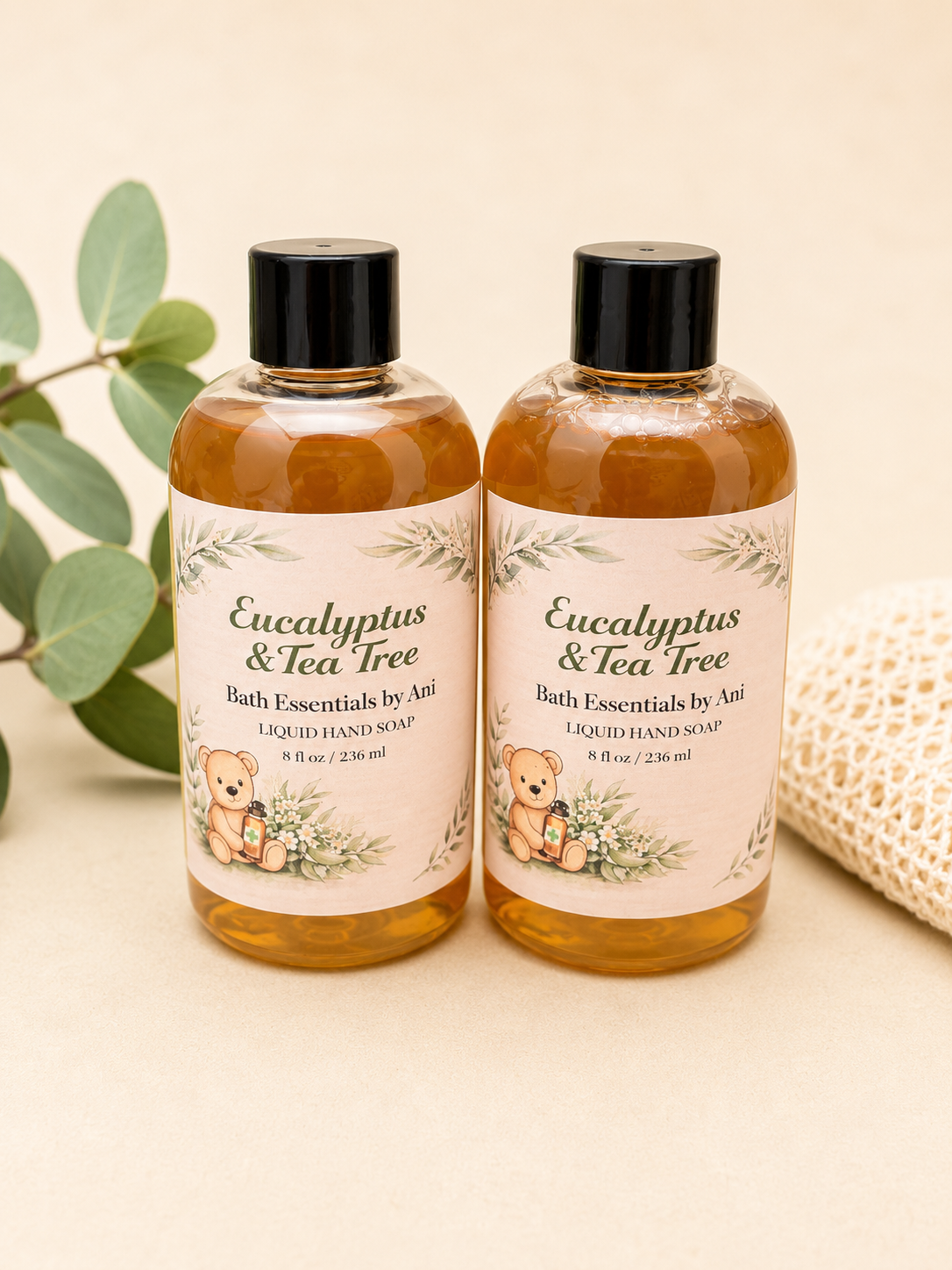 Two eucalyptus & tea tree liquid hand soap bottles with black pumps