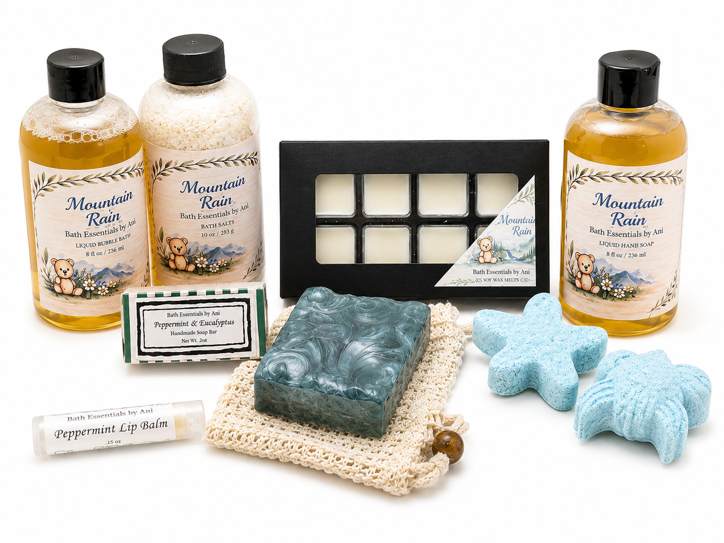 Bath gift set arranged with bottles, black tray box, soap bars, and blue bath bombs