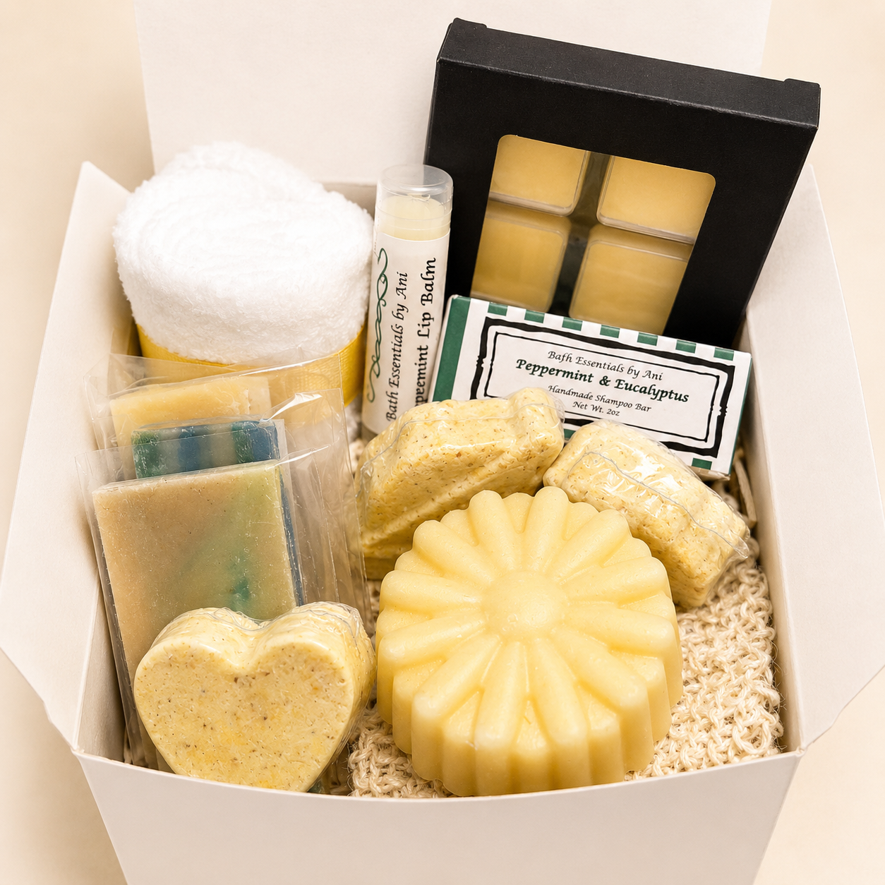 Scented wax melt gift set in open box featuring yellow soap bars, bath items, and spa accessory.