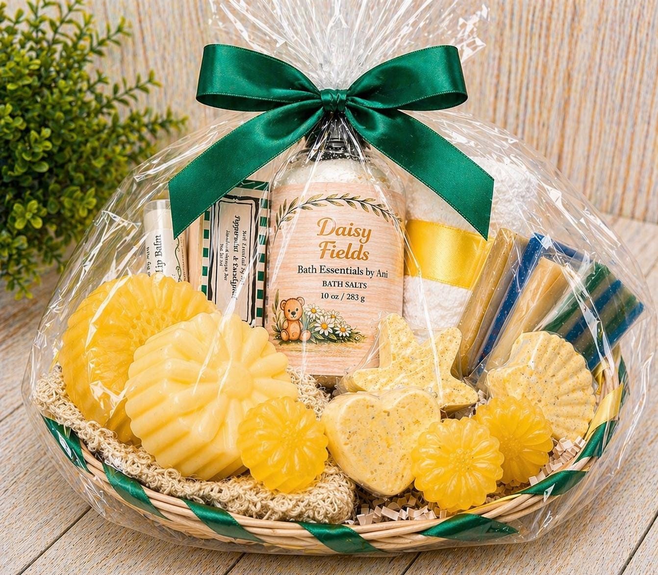 Wrapped yellow daisy bath gift basket with green bow, soaps, and bath salts jar
