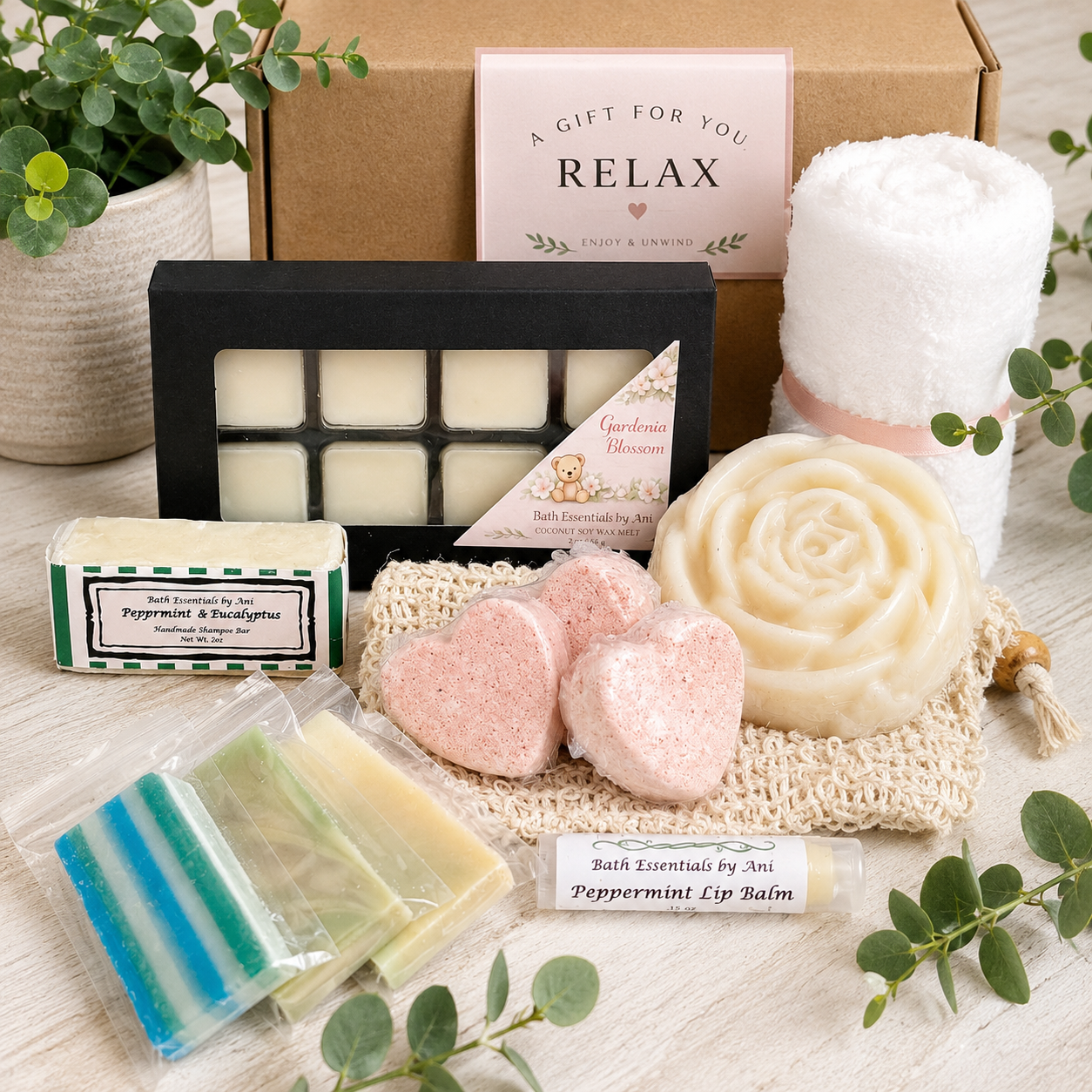 Bath gift box with wax melt squares, heart bath bombs, swirl soap, towel roll and lip balm