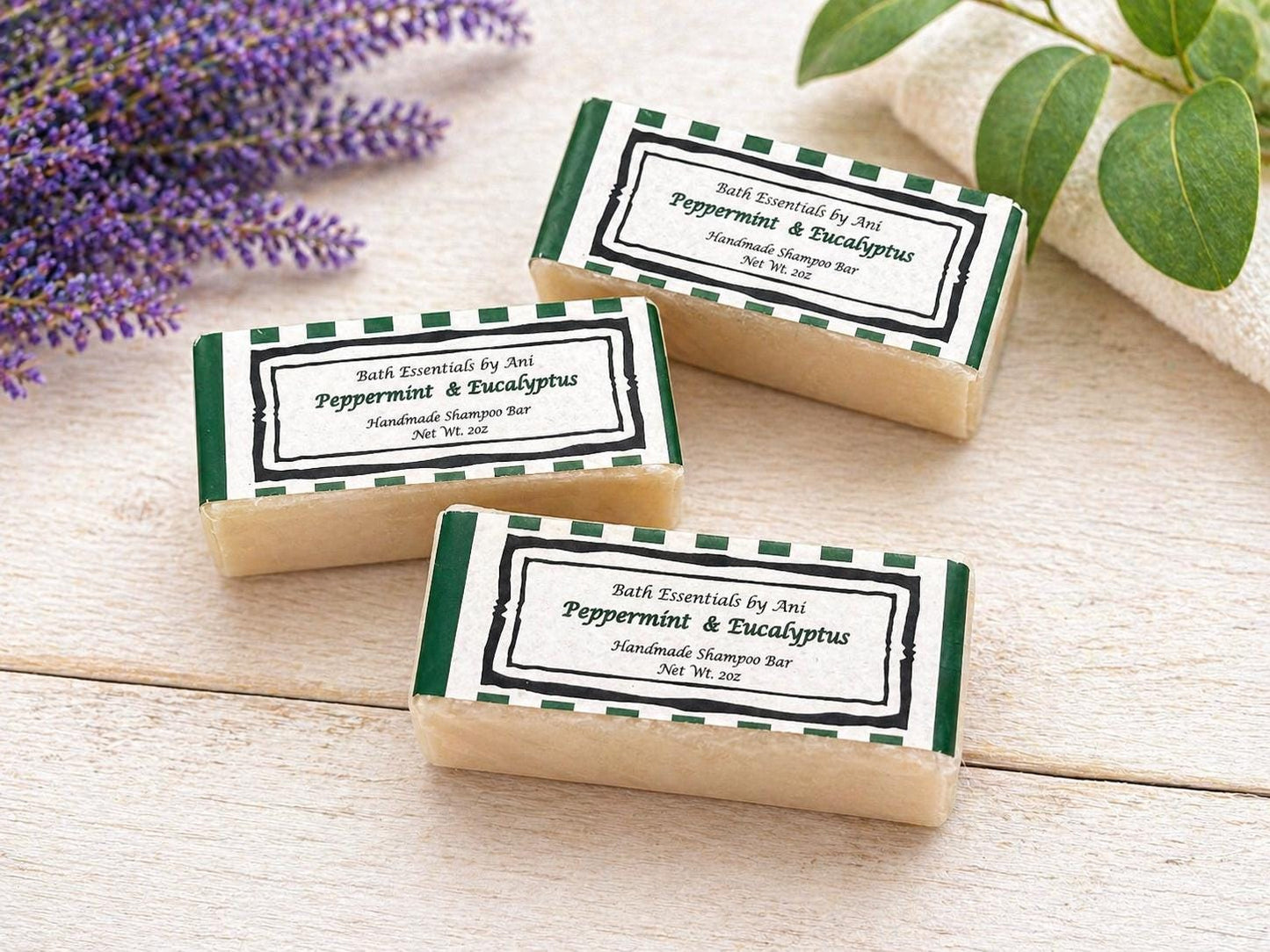 Peppermint and eucalyptus bath soap bars on a light surface with green labels