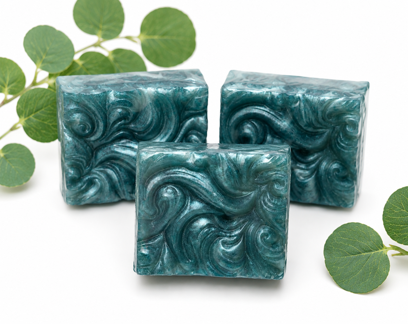 Set of three teal swirled soap bars with decorative marbled texture
