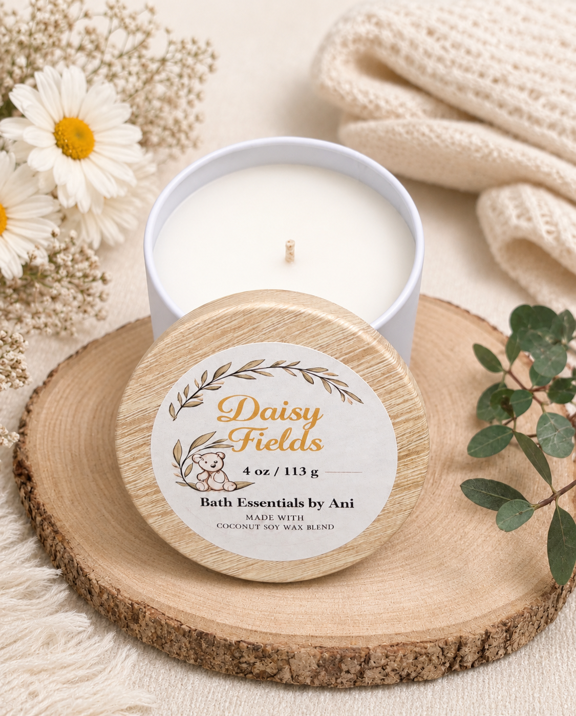 Round wood-slice candle lid with Daisy Fields label and white candle flame