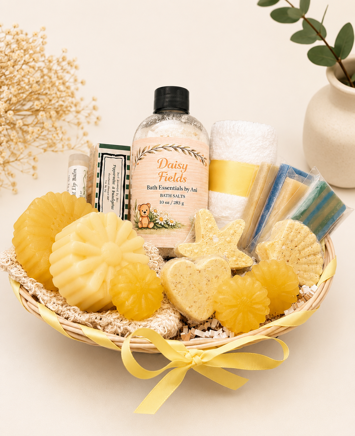 Gift basket with yellow soaps, bath salts, and bottles wrapped with a yellow ribbon