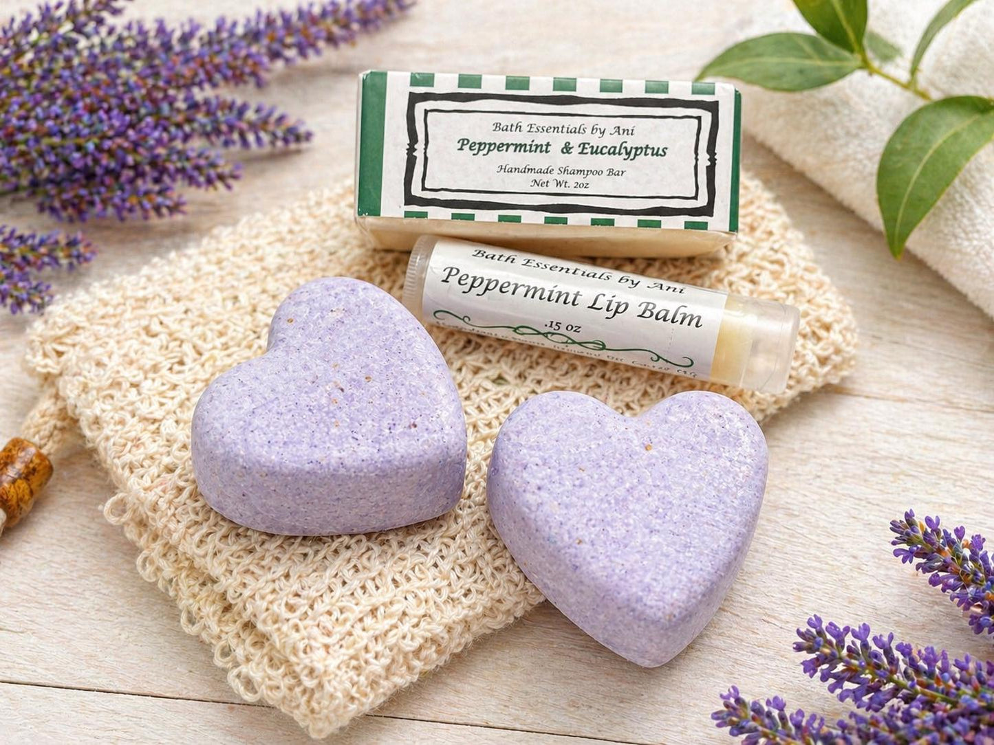 Lilac heart bath bombs and peppermint lip balm tubes on a cloth pad