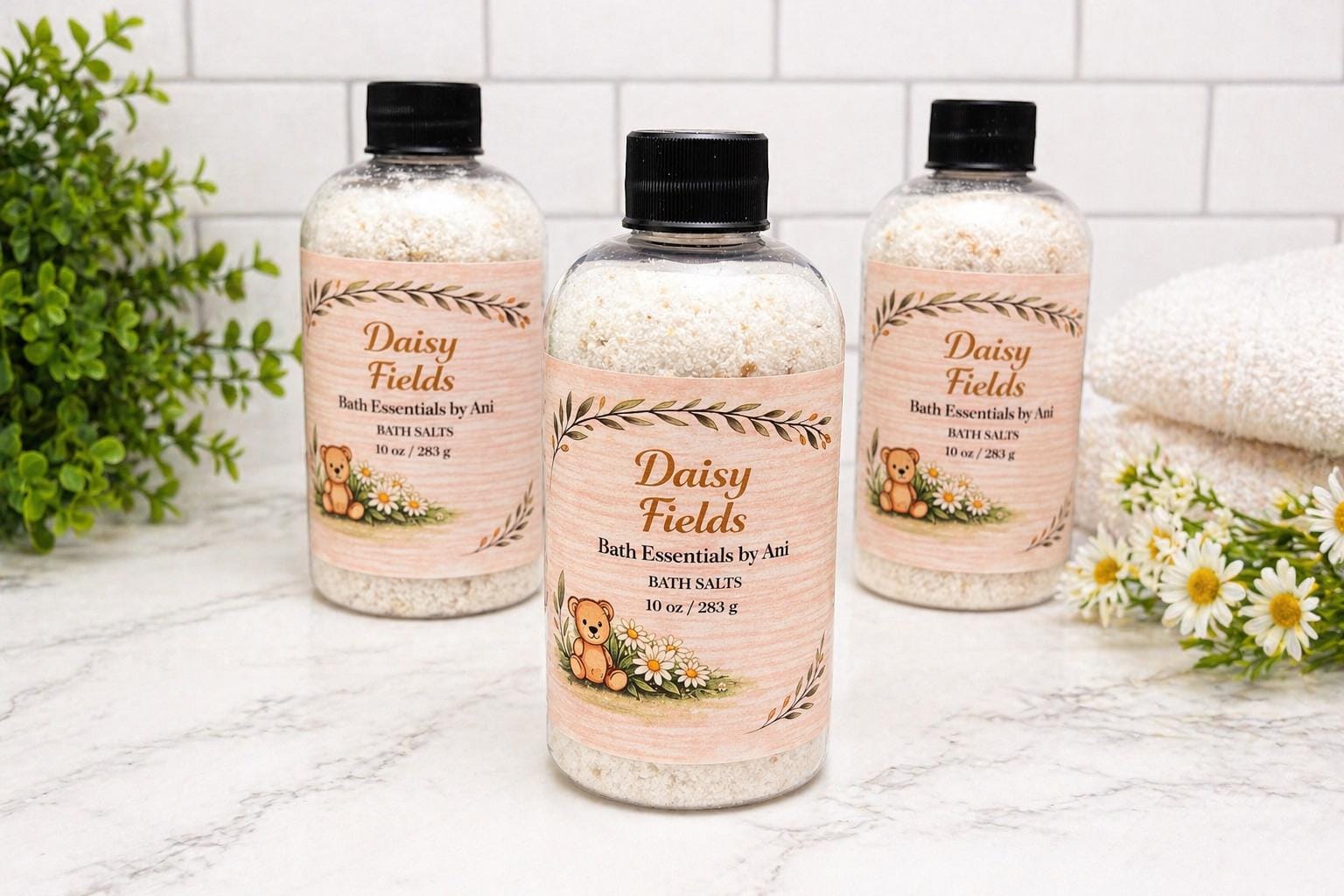 Daisy Fields bath salts bottles with yellow soap pieces and a folded white towel