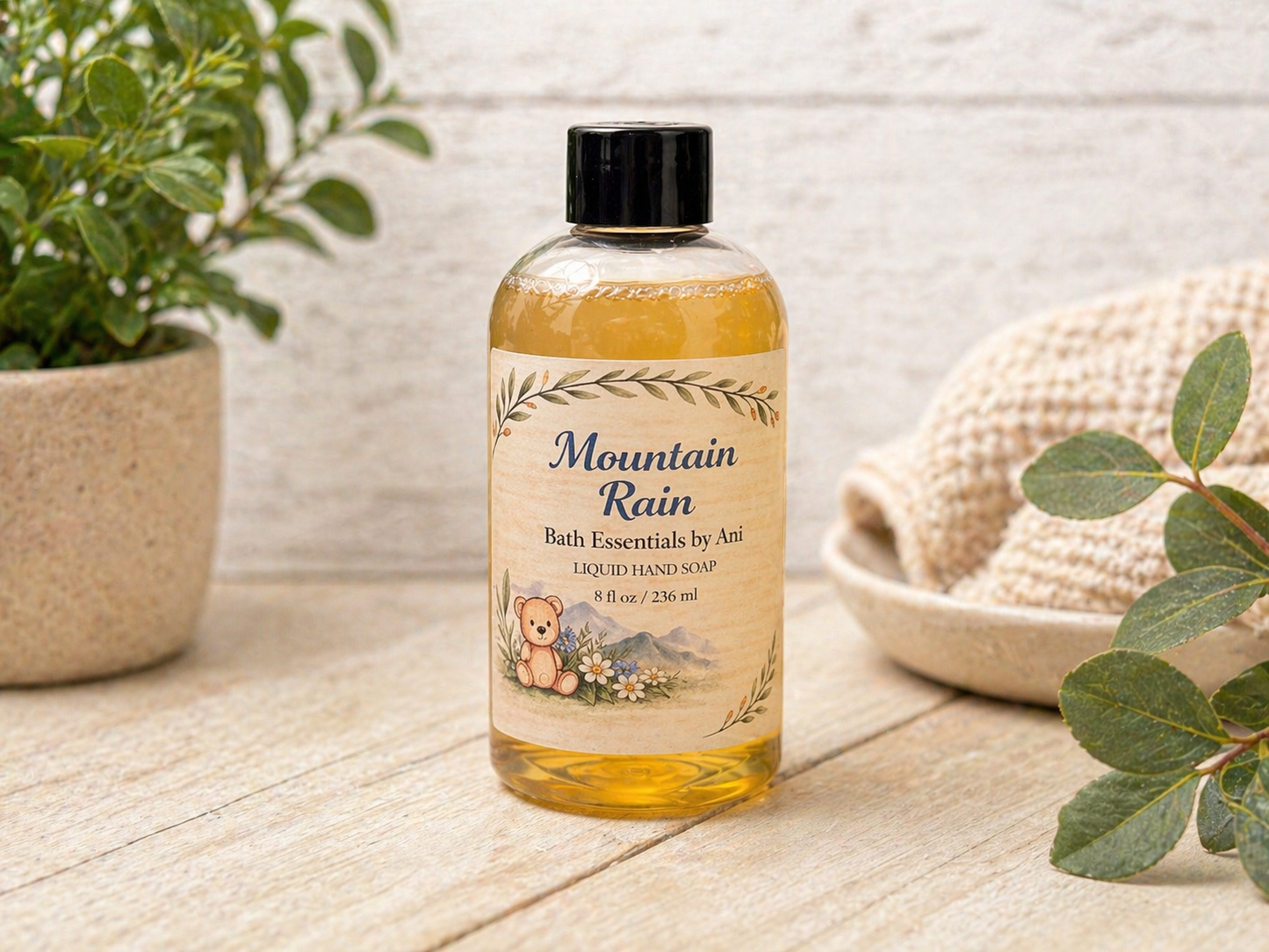 Bottle of amber liquid hand soap with black pump and Mountain Rain label
