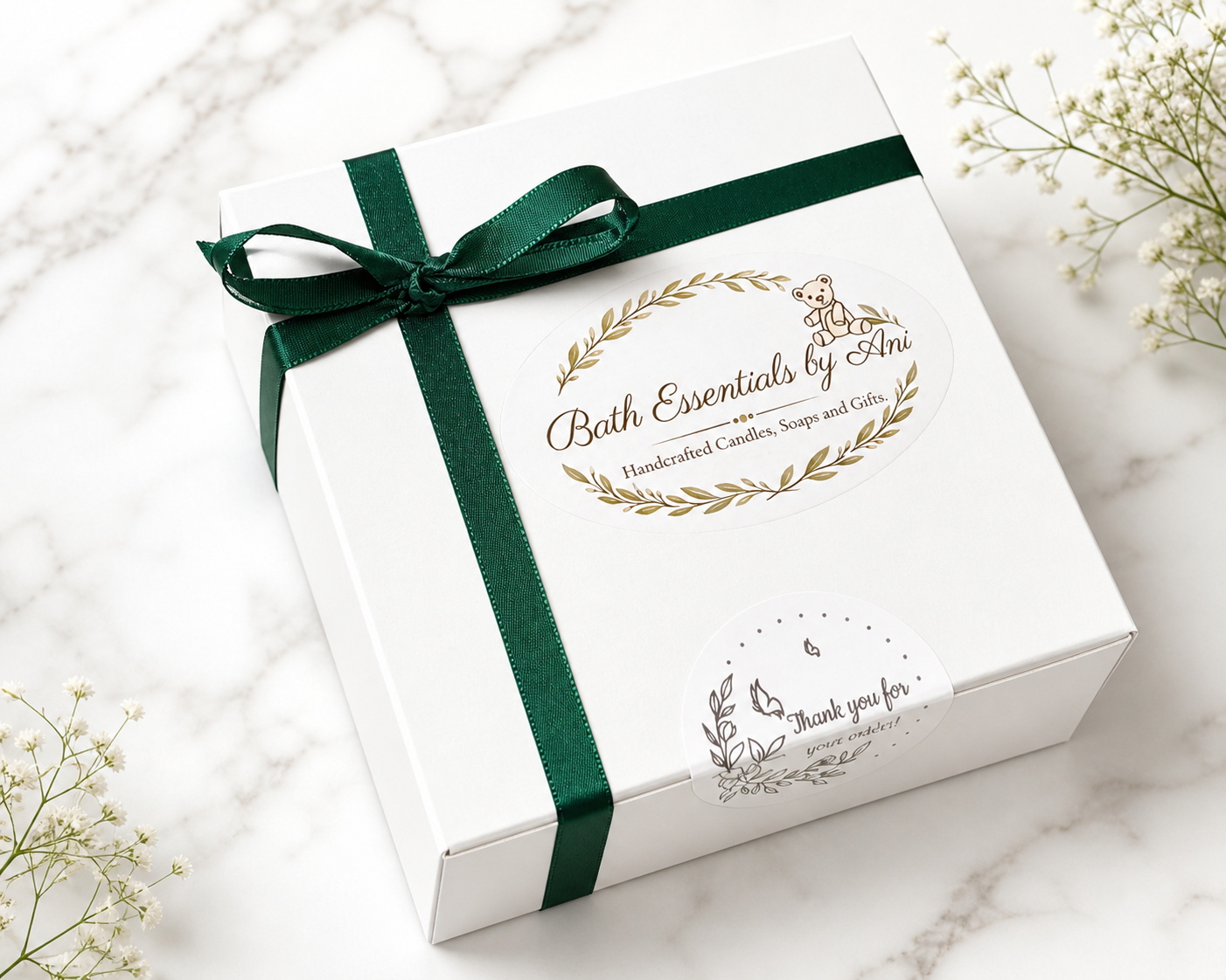 White gift box tied with a green ribbon bow with an oval botanical emblem
