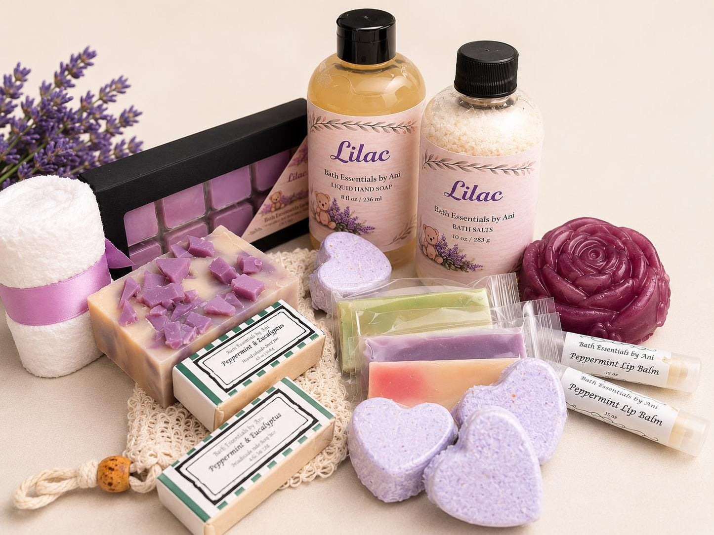 Lilac spa bath pamper box with bottles, purple soap cubes, heart bath bombs, and bars