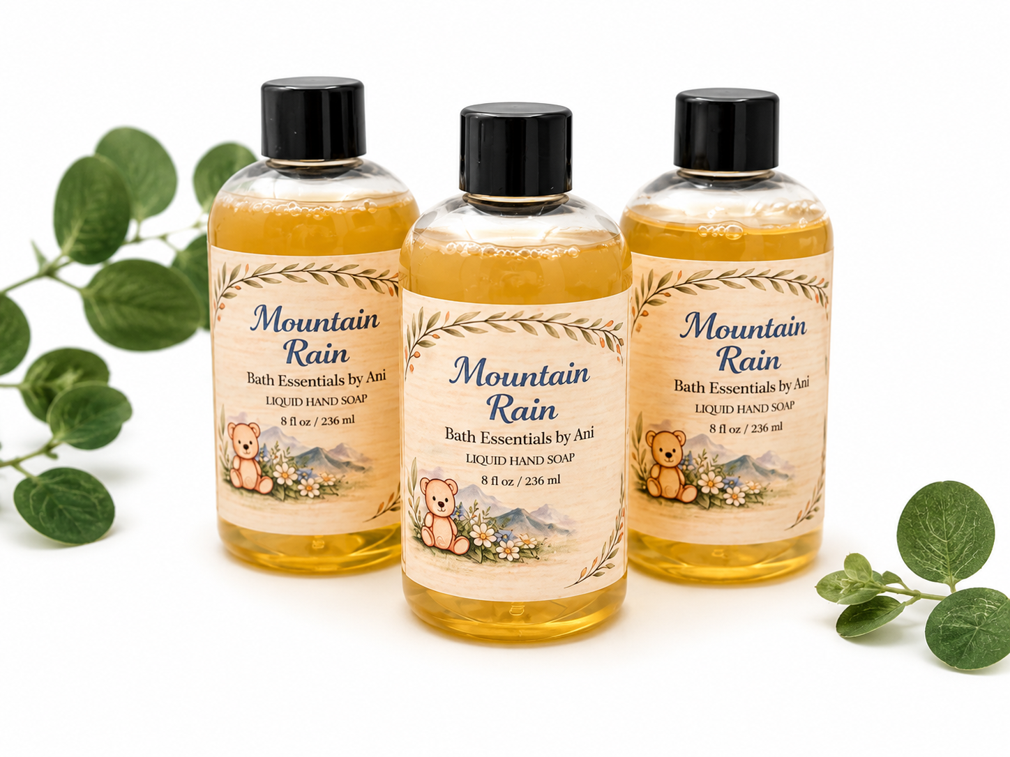 Set of three amber liquid hand soaps with black pumps and Mountain Rain labels