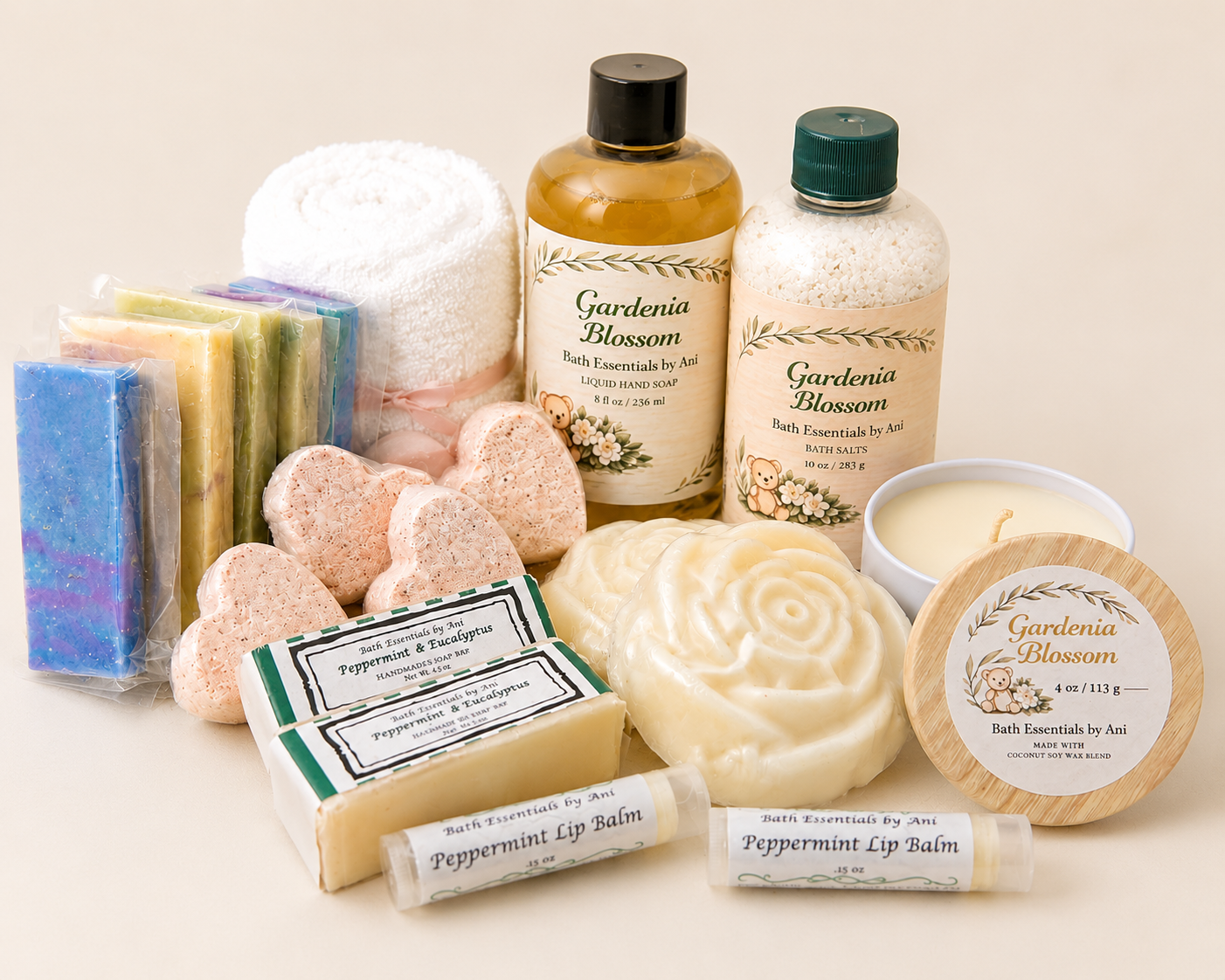 Spa gift box with swirl soap, heart soap bars, candle, and labeled bath bottles.