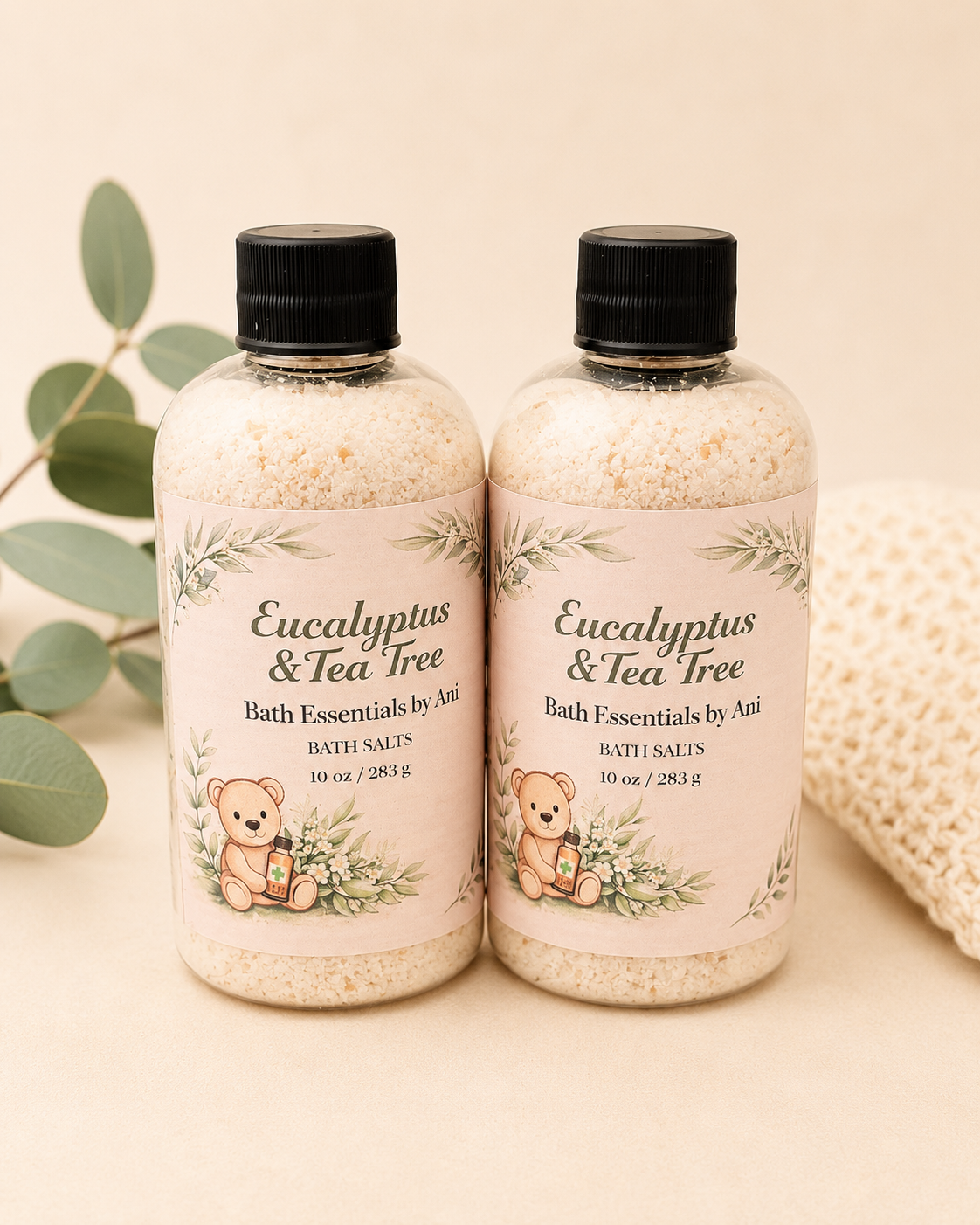 Two eucalyptus & tea tree bath salt bottles with black caps