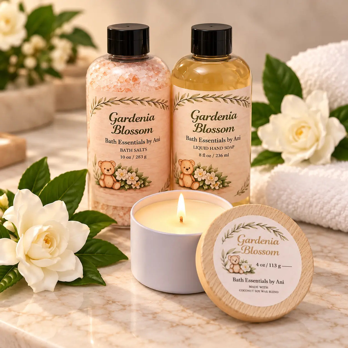 Gardenia blossom bath essentials bottles with lit candle and round bath essentials lid