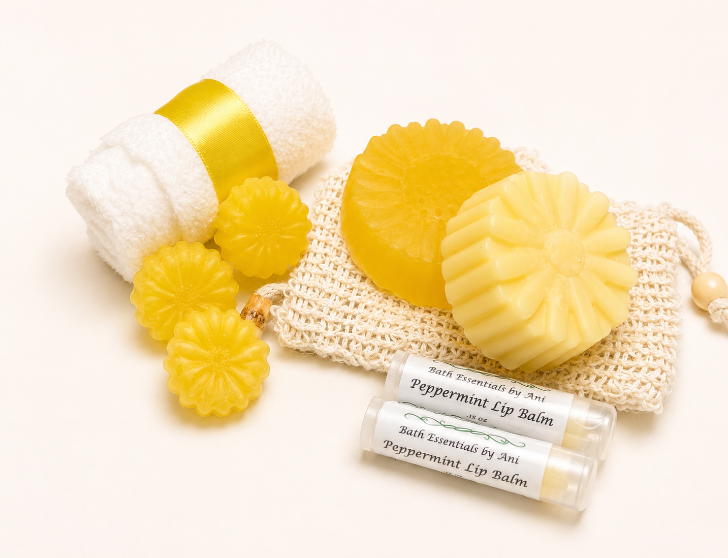Yellow daisy bath products with bar soaps, bath bomb pieces, washcloth pouch, and lip balm