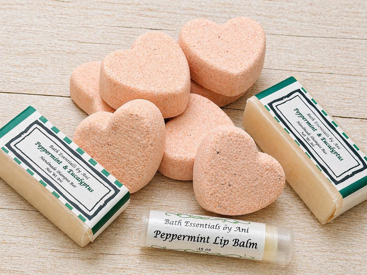 Bath scrub bars and peppermint lip balm tubes on a light wooden surface
