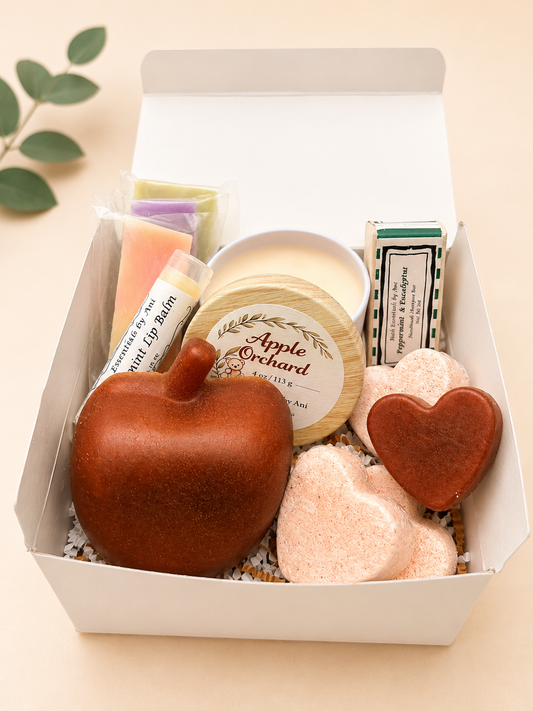 Self care gift box with round candle, heart soaps, and bath bombs