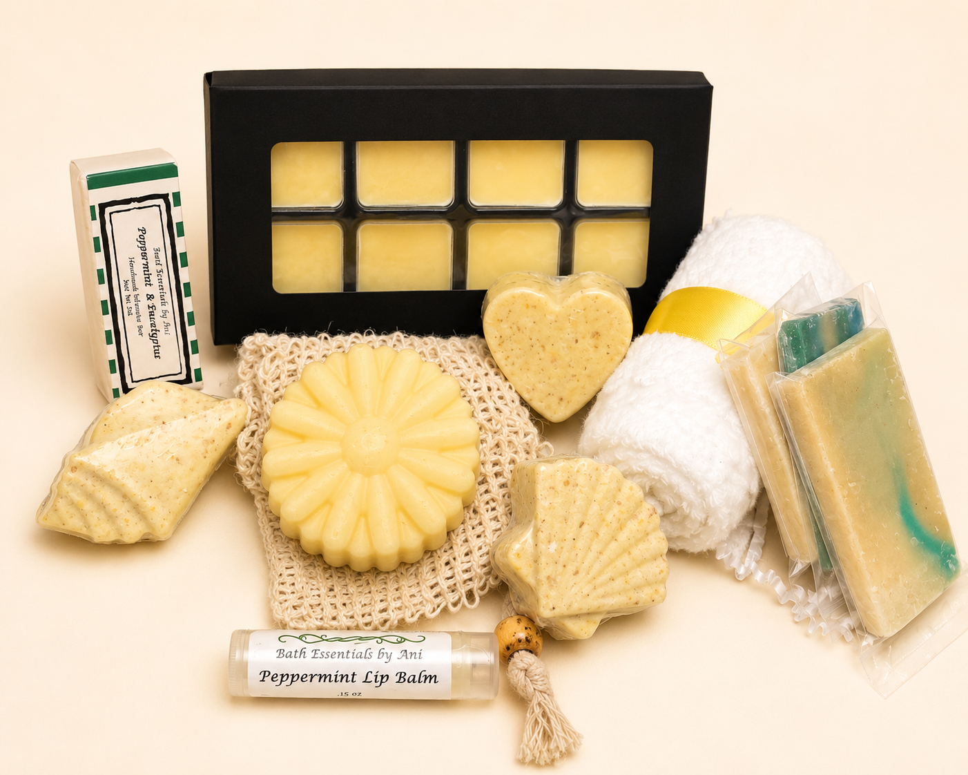 Bath gift set with black tray, yellow flower soap, heart soap, balm bars, and wax melts