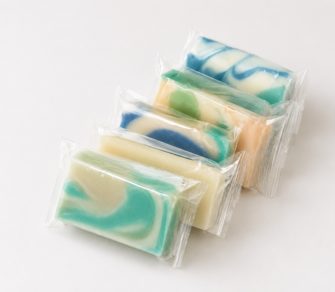 Variety pack of mini wrapped soap bars with teal and green swirls
