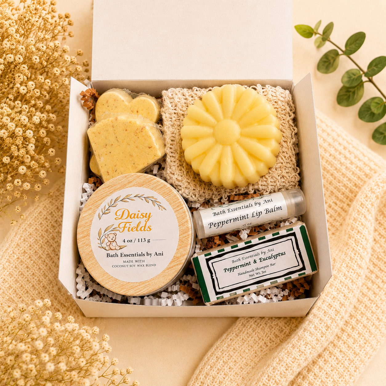 Bath essentials gift box with yellow flower soap, scrub bars, and bath balm tube