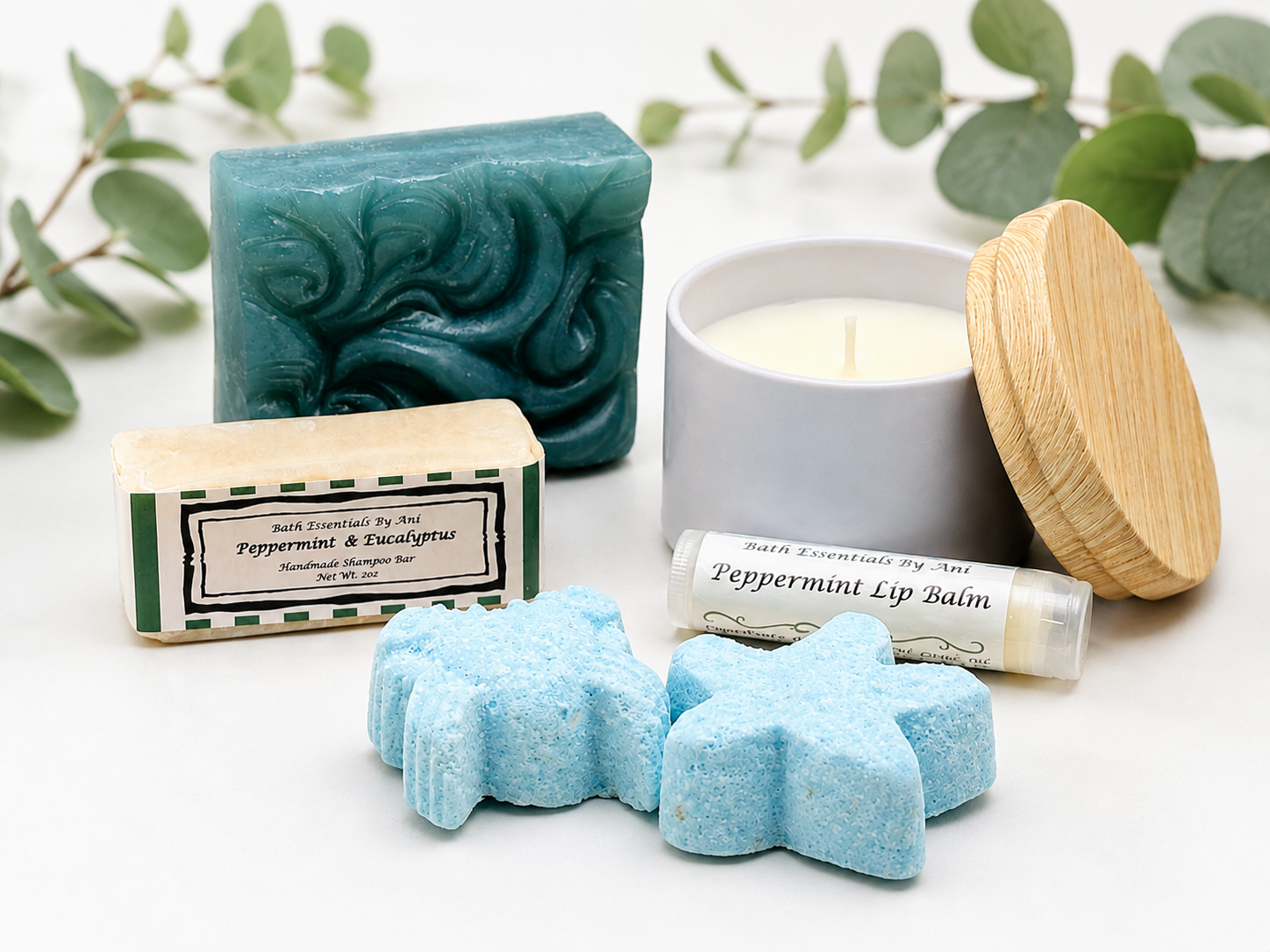 Blue soap bars, peppermint lip balm, star-shaped bath bombs, and a wooden candle lid