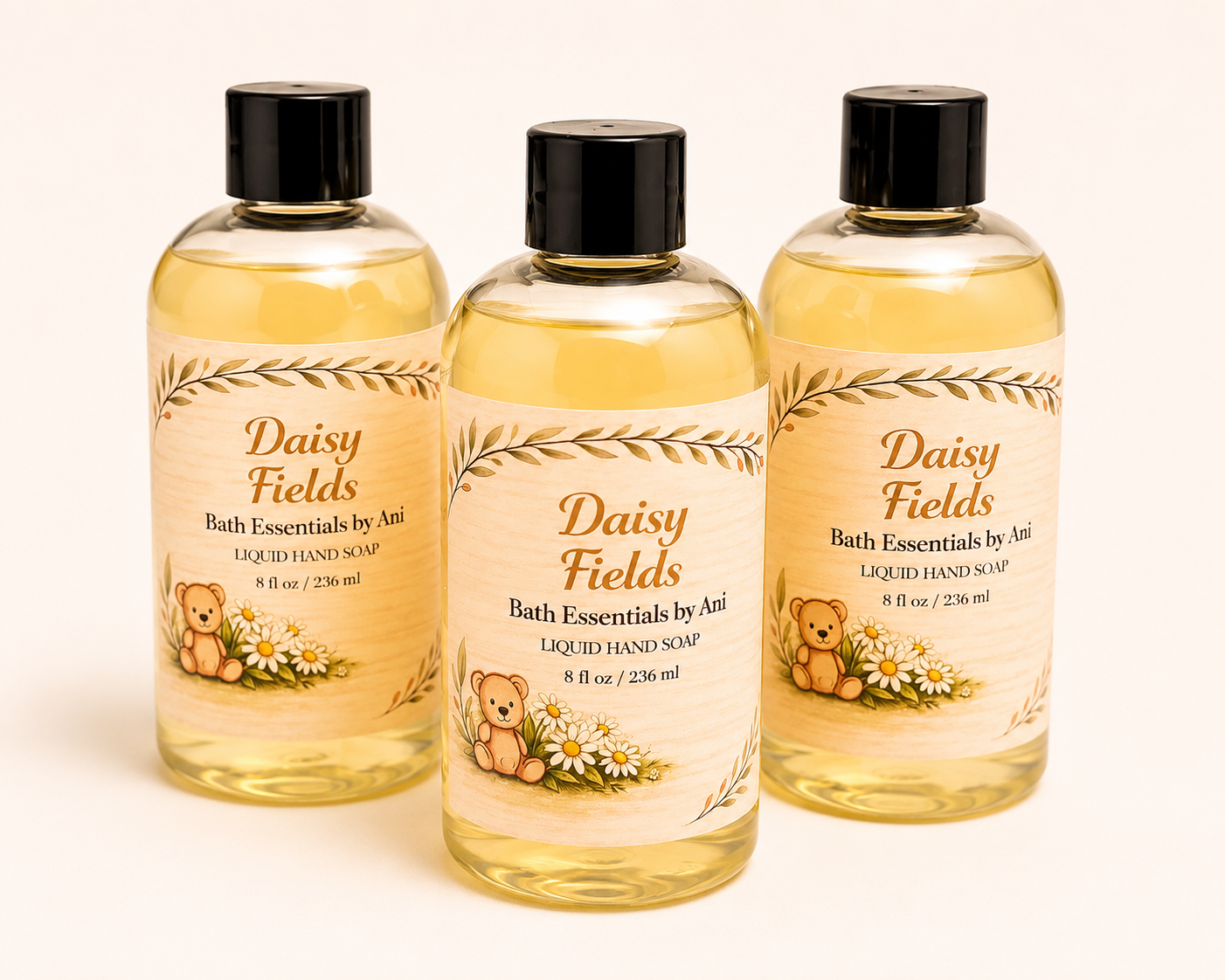 Three Daisy Fields bath essentials bottles with black caps in amber yellow