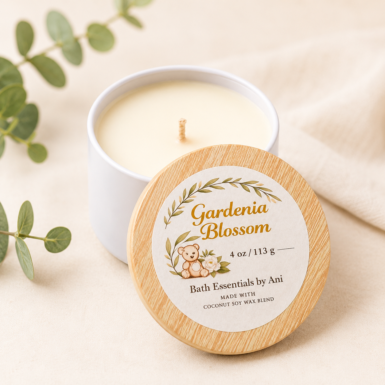 Lit candle with Gardenia Blossom bath soap round and self care gift items