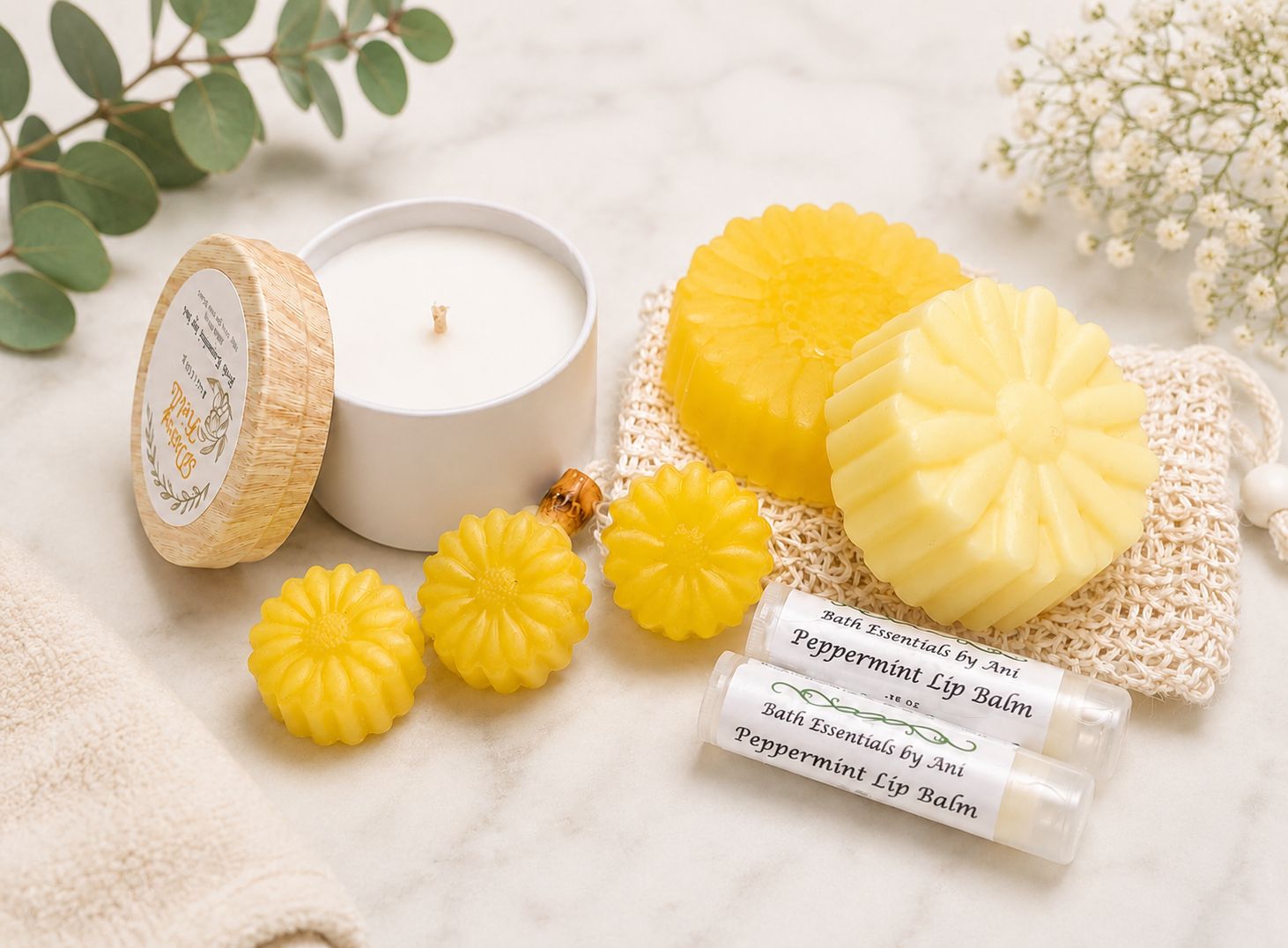 Spa gift set with yellow flower soaps, lip balm, and a white candle jar
