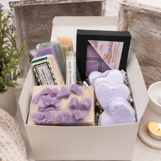 Handmade spa gift box with purple wax melts, soap bars, and spa-scented accessories