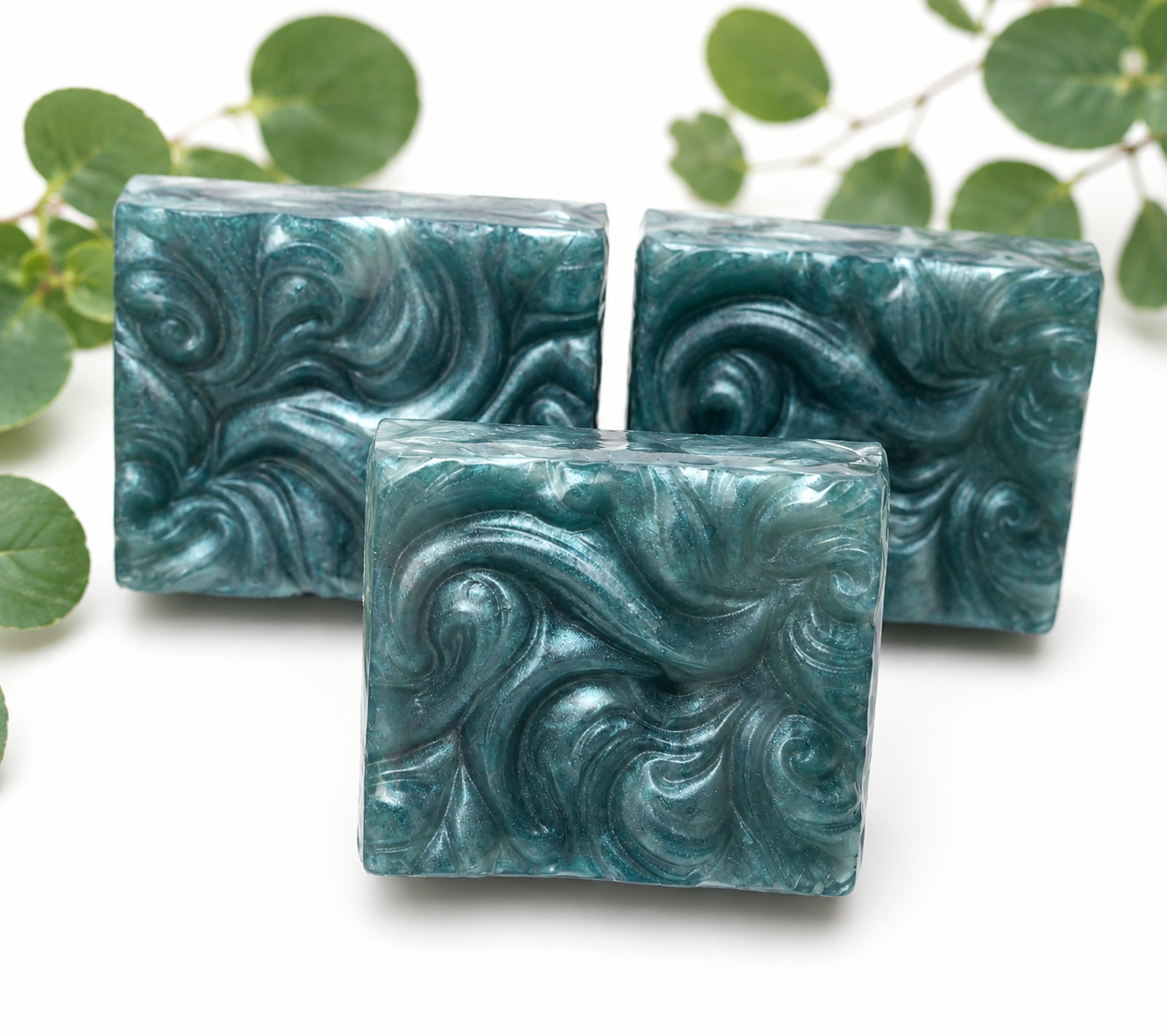 Set of teal-blue handmade soap bars with swirled marbled texture