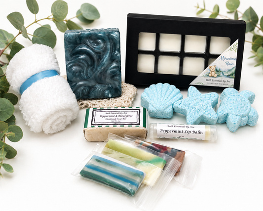 Assorted bath pamper items with blue soaps, bath bombs, and gift box tray