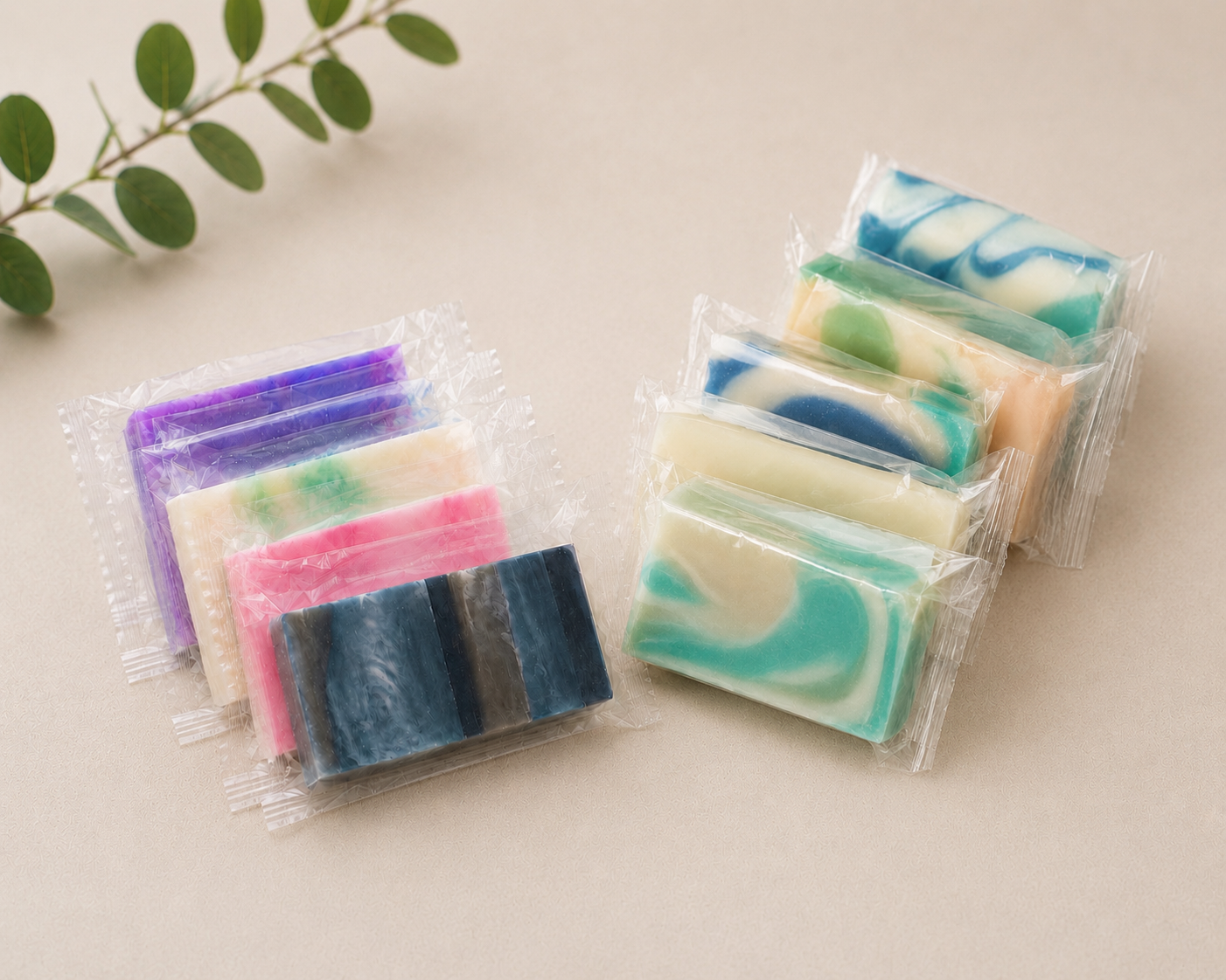 Two groups of individually wrapped mini soap bars, assorted colors in clear plastic