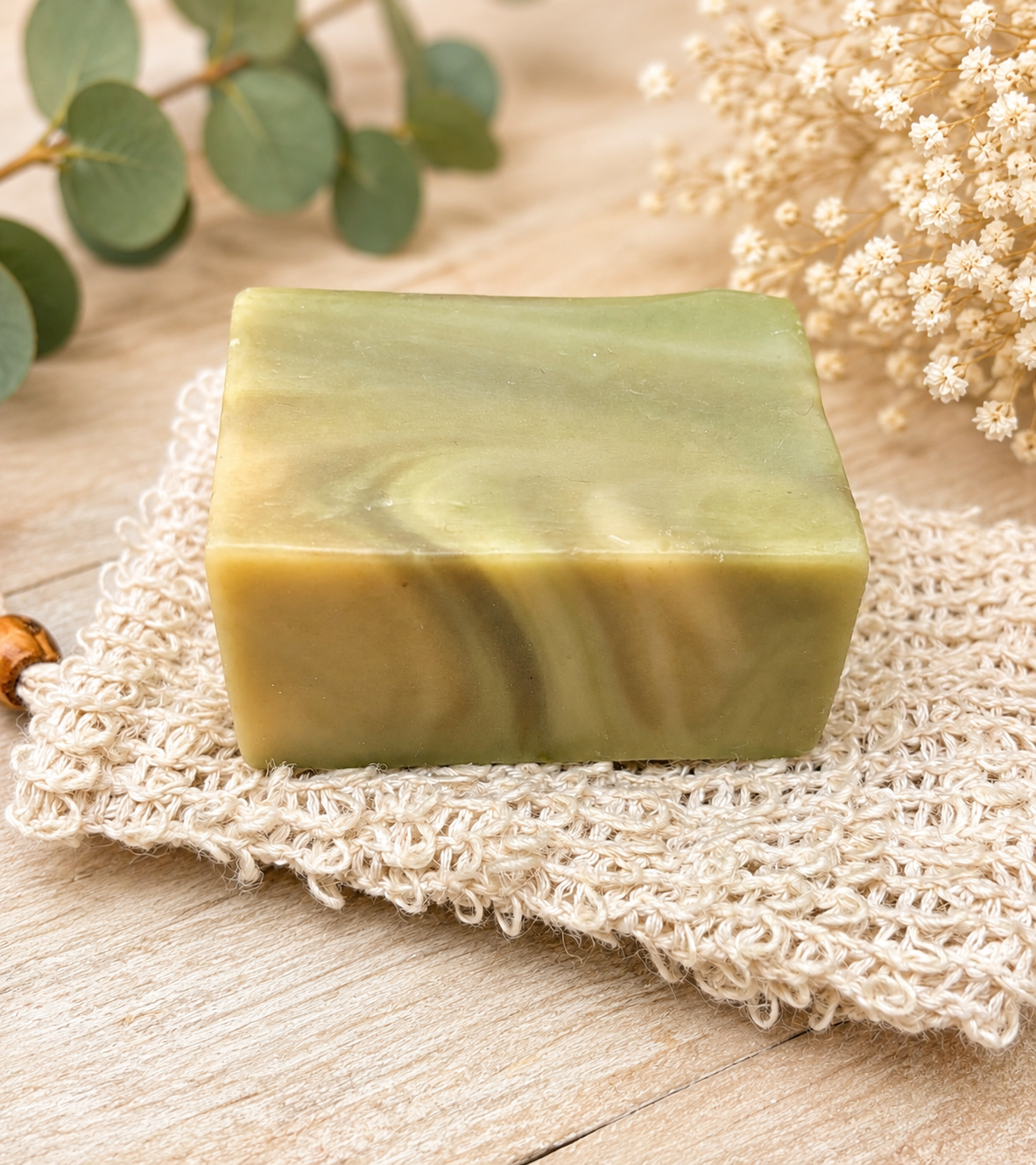 Green eucalyptus-style soap bar on textured bath cloth