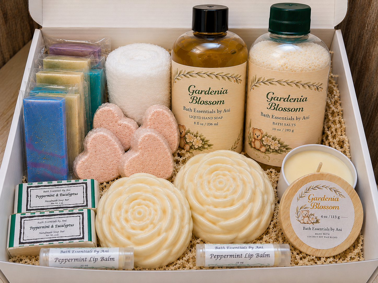 Spa gift box with assorted bath essentials: bottles, soaps, bath bombs, candle, lip balm