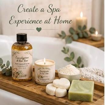 Spa gift set tray with eucalyptus lotion bottle, candle, soap bars, and bath accessories