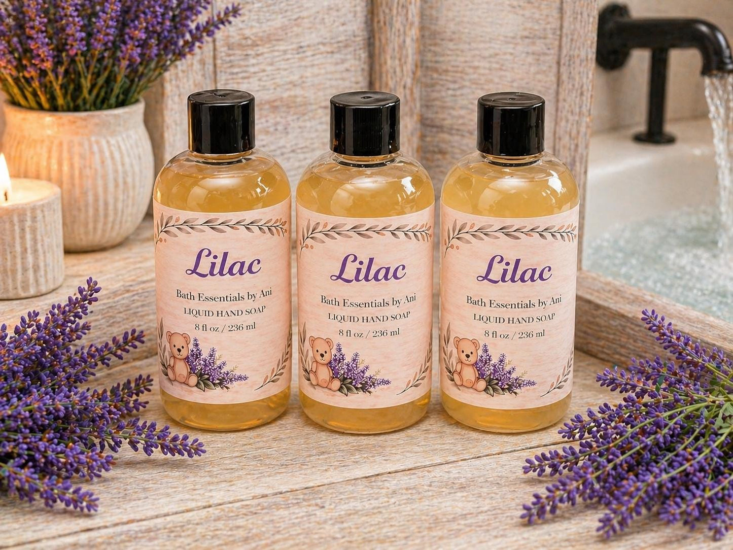 Three Lilac body wash bottles with lavender accents and a shower spray in background
