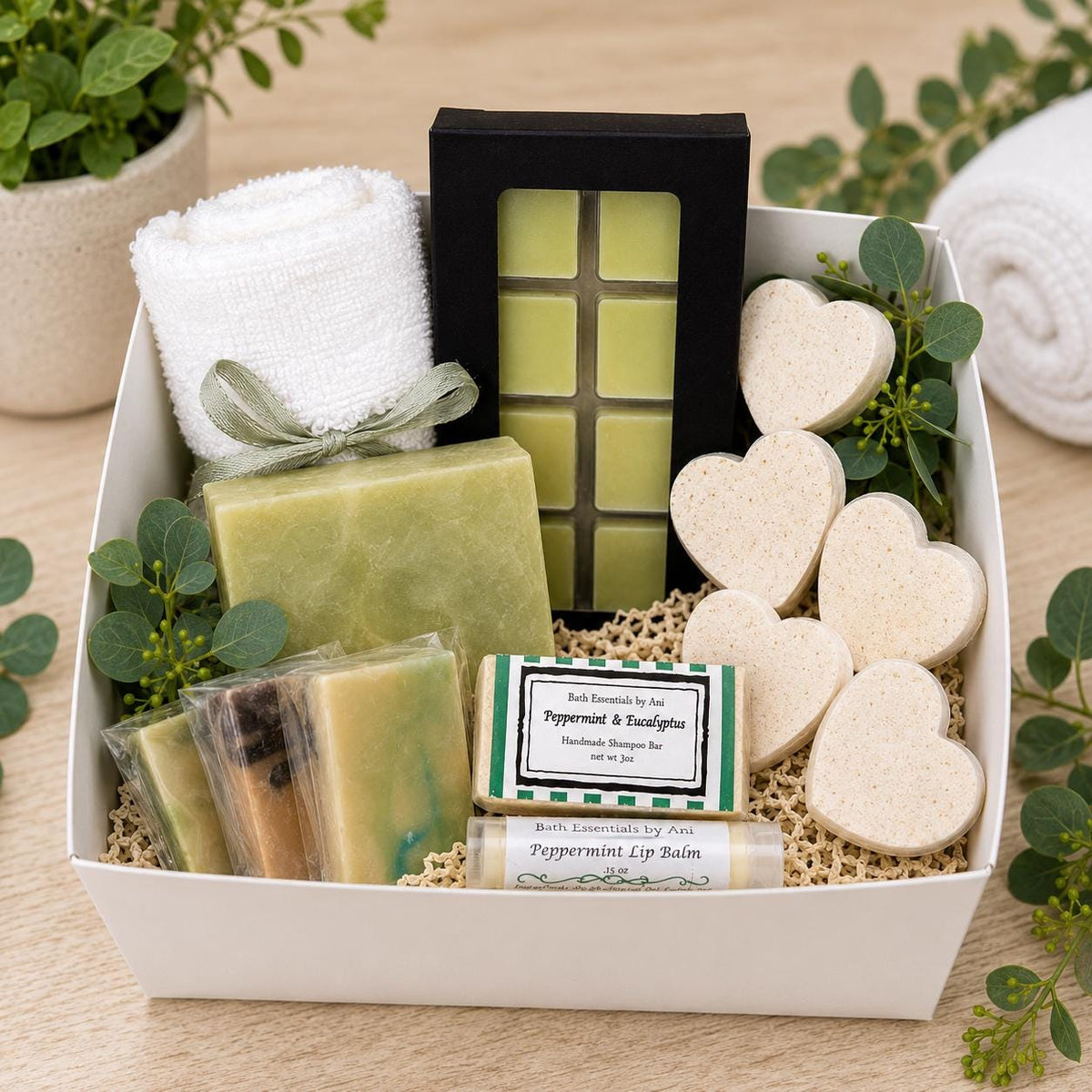 Handmade spa gift basket with green soap bars, wax melt squares, and heart-shaped soaps.