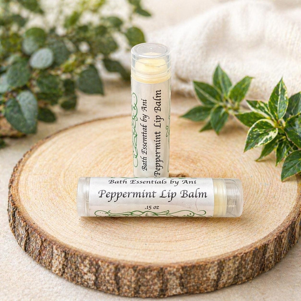 Peppermint lip balm tube on a wooden slice