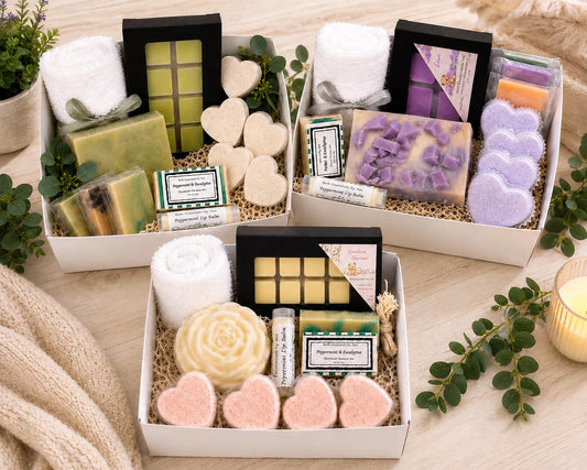 Handmade spa gift basket with soap bars, wax melts, lip balm, and folded white towels.
